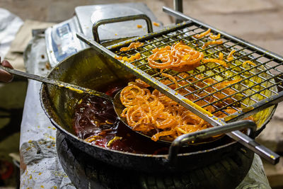 Indian traditional sweet jalebi in sugary syrup from flat angle