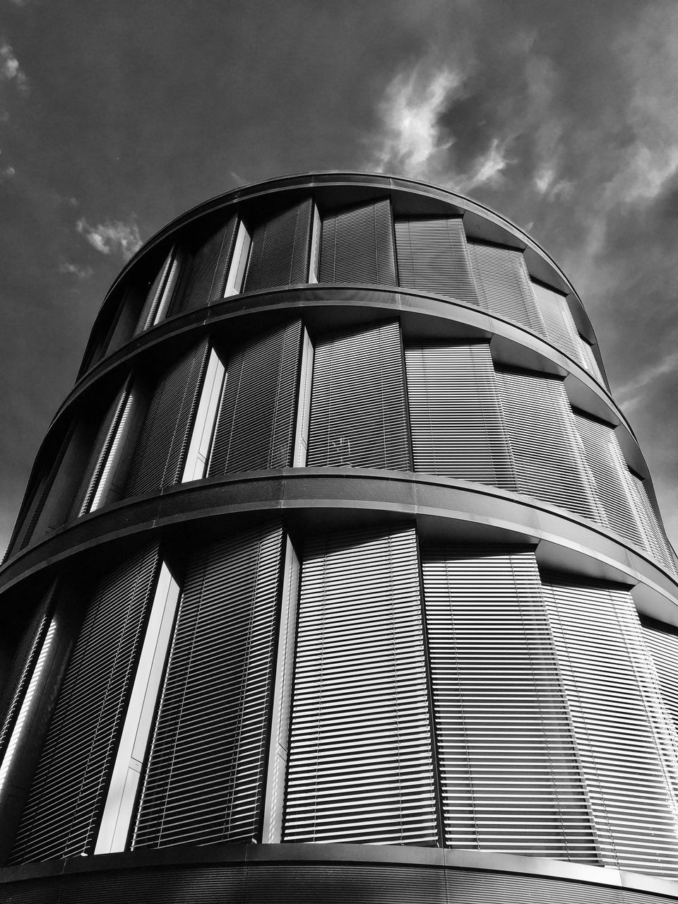 building exterior, low angle view, architecture, built structure, sky, cloud - sky, day, modern, outdoors, no people, window, skyscraper, city