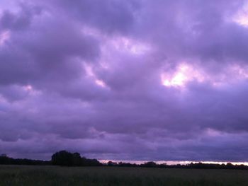 Scenic view of dramatic sky over field