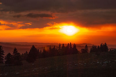 Scenic view of silhouette landscape against orange sky sunset