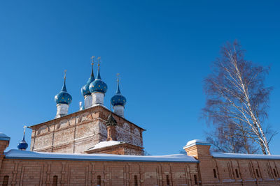 Low angle view of building against clear blue sky