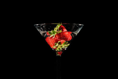 Close-up of red berries against black background