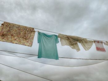 Low angle view of clothes drying on clothesline against sky