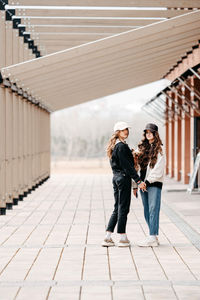 Full length of young woman standing in city