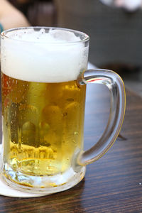 Close-up of beer glass on table