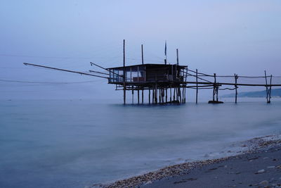 Pier on sea against clear sky