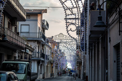 Street amidst buildings in city against sky