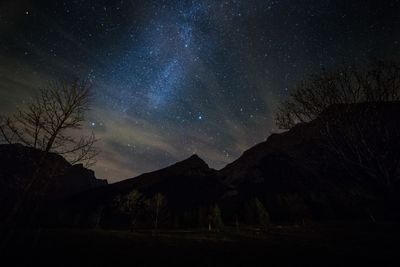 Scenic view of mountains against sky at night