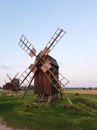 Traditional windmill on field against sky