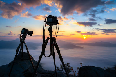 Low angle view of silhouette on beach against sky during sunset