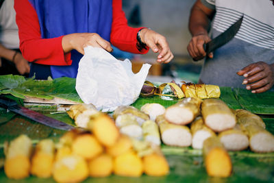 Vendor seling grilled sticky rice  at street food market
