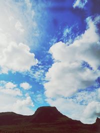 Low angle view of mountain against cloudy sky
