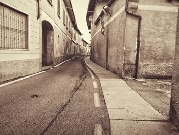 Empty alley amidst buildings in city