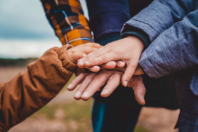 Close-up of the hands of a united family.	