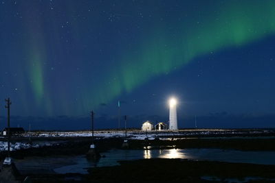 Aurora borealis appearance at grótta island lighthouse in reykjavi