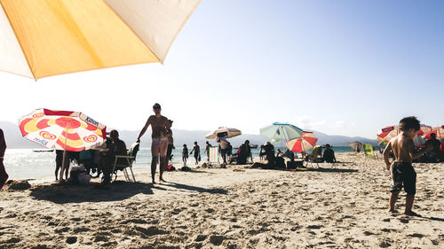 People on beach against sky