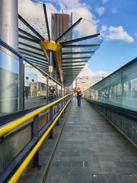 Rear view of people walking on railroad station platform