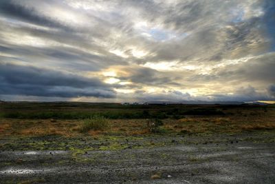 Scenic view of landscape against cloudy sky