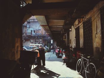 People on street amidst buildings in city