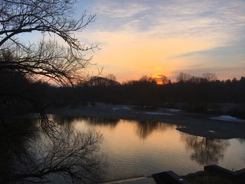 Scenic view of lake against sky during sunset