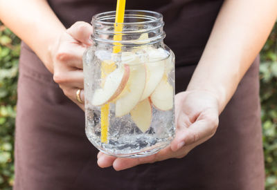 Midsection of woman holding drink