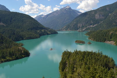 High angle view of lake and mountains against sky