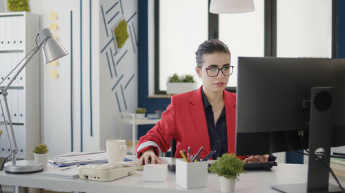 Businesswoman using laptop at office