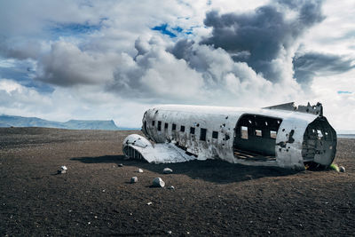 Airplane on runway against sky