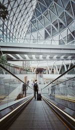 Rear view of people walking in modern building