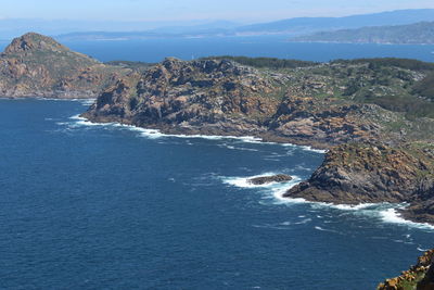 Scenic view of sea and mountains against sky