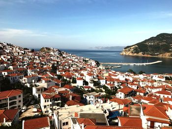 Town by sea against sky