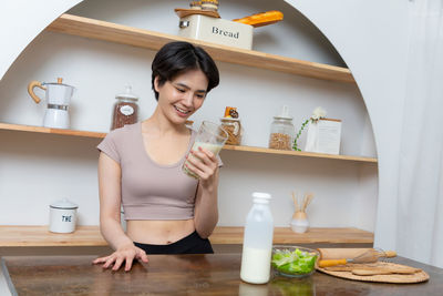 Portrait of young woman sitting at home