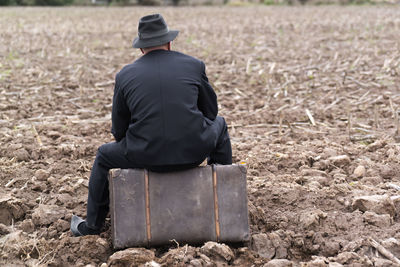 Rear view of man working at farm