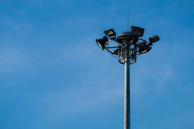 Low angle view of street light against blue sky