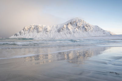 Scenic view of frozen sea against sky