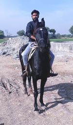 Portrait of man sitting on horse