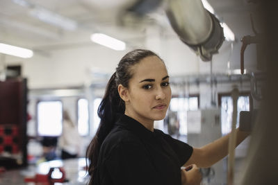 Side view portrait of auto mechanic student at workshop