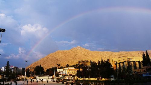 Panoramic view of rainbow over city buildings