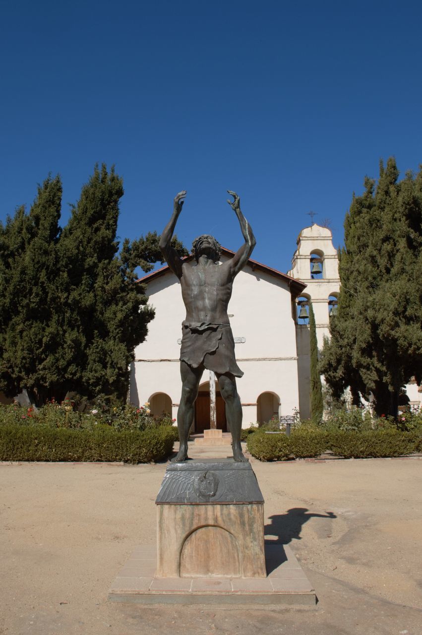 sky, tree, plant, art and craft, clear sky, sculpture, representation, nature, statue, day, creativity, human representation, no people, sunlight, male likeness, architecture, blue, craft, outdoors