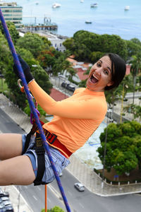 A female rappellist descending the elevator lacerates. very tall monument. salvador bahia brazil.