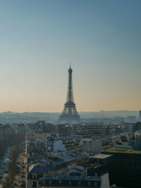 Buildings in city against clear sky