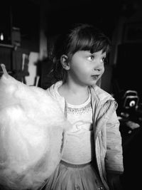 Cute girl with cotton candy at night