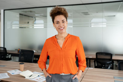 Portrait of young woman standing in office