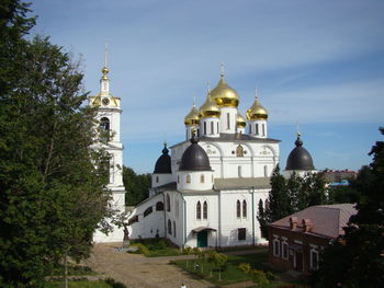 Church by building against sky