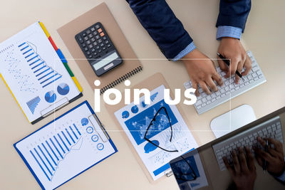 Directly above shot of businessman working over graph on table