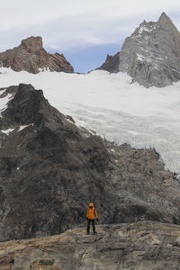 Person standing on mountain during winter