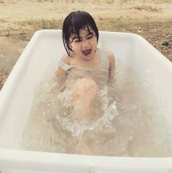 High angle view of shirtless boy in swimming pool