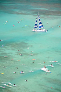 High angle view of people on sailboat in sea