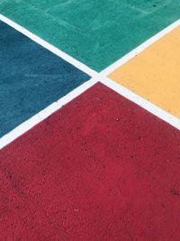 High angle view of road marking on color field