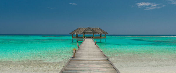 Wooden jetty over the beautiful maldivian sea